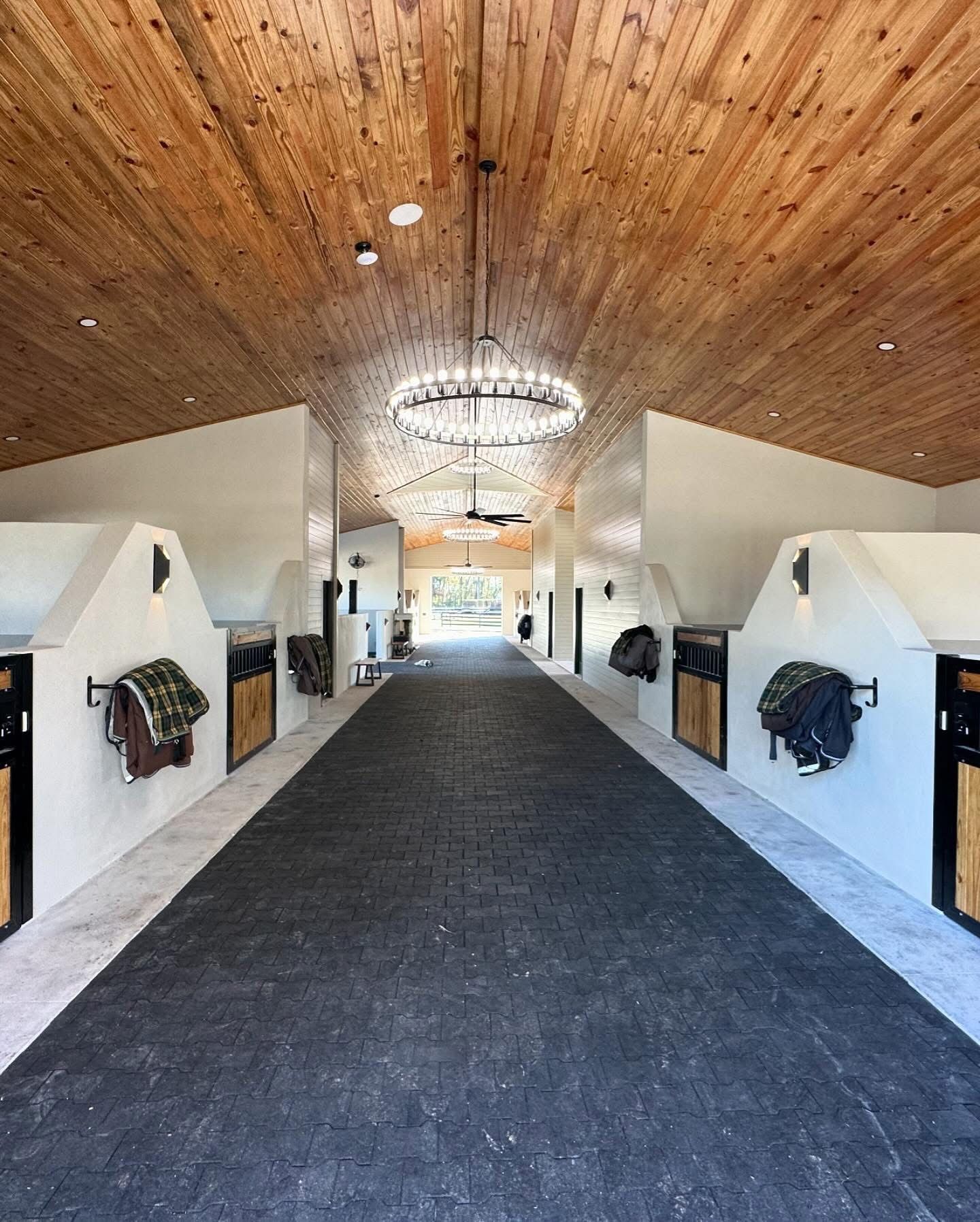 Daylit barn aisle with pine ceiling and blanket bars